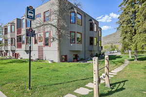 View of side of property with a lawn