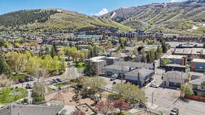 Aerial view of property's location with mountains and nearby suburban area