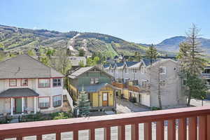 View of mountain backdrop featuring nearby suburban area