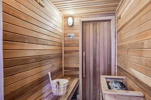 Sauna with wood walls and wooden ceiling