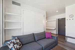 Living area featuring wood finished floors and recessed lighting