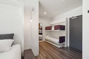 Bedroom with dark wood-type flooring and recessed lighting