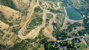 Aerial view of property and surrounding area with a large body of water