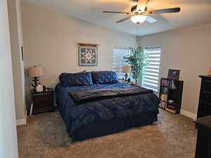 Bedroom featuring carpet floors, baseboards, and a ceiling fan