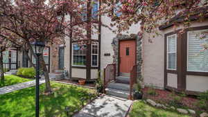 View of exterior entry featuring stucco siding