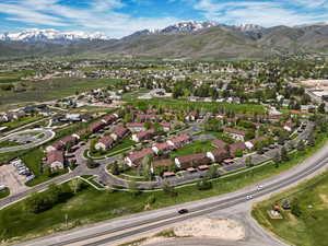Aerial view of property's location featuring a mountainous background and nearby suburban area