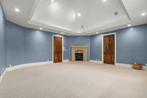 Bedroom featuring a raised ceiling, carpet floors, recessed lighting, and baseboards