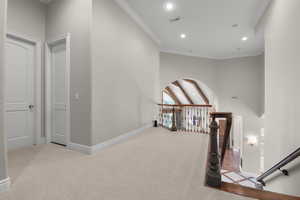 Hallway with an upstairs landing, carpet floors, recessed lighting, baseboards, and ornamental molding