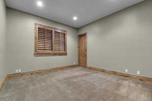 Spare room with carpet floors, baseboards, and recessed lighting