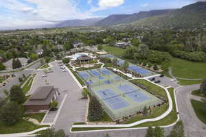 Drone / aerial view of community pickleball courts with mountain background