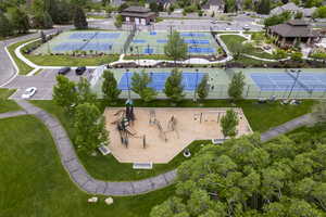 Drone / aerial view of community pool and pickleball courts