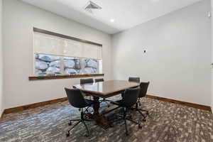 Carpeted office space featuring baseboards and recessed lighting