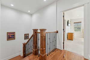 Stairs featuring hardwood / wood-style floors, recessed lighting, and baseboards