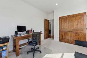 Carpeted home office featuring recessed lighting