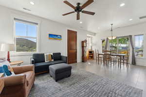 Living area with recessed lighting, plenty of natural light, a ceiling fan, and baseboards