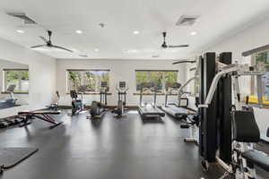 Gym with a ceiling fan, recessed lighting, and baseboards
