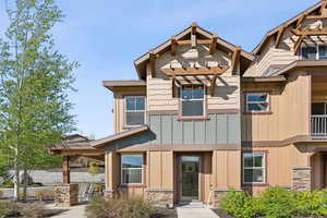Multi unit property with board and batten siding and stone siding