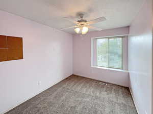 Bedroom 2 upstairs with a view of the front of the house and boasting cozy new carpet