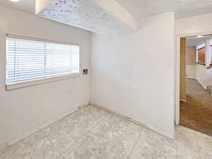 Large laundry room with storage and lots of natural light and a view of the backyard