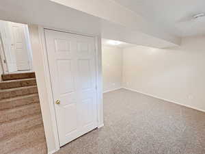 Basement bedroom 4 with large storage closet and natural light and a view of the front yard