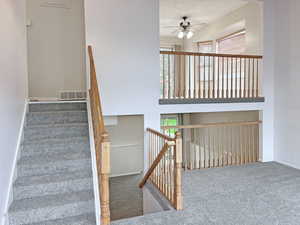 Entry into the home, featuring the living room and a towering ceiling