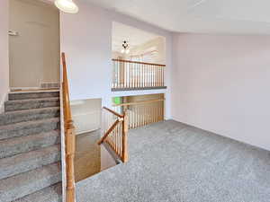 Entry into the home, featuring the living room and a towering ceiling