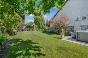 View of grassy yard featuring a pergola