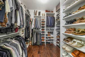 Walk in closet with wood finished floors