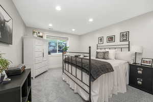 Bedroom featuring light colored carpet and recessed lighting