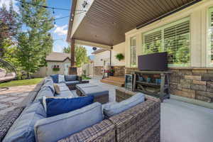 View of patio with an outdoor hangout area and an outbuilding