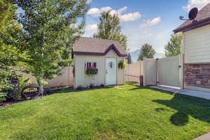 Fenced backyard with a shed and a gate