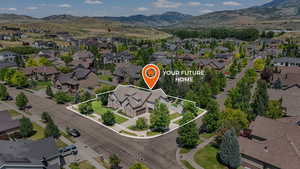 Aerial perspective of suburban area with property boundaries highlighted and mountains