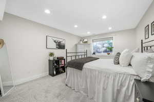 Bedroom featuring light colored carpet and recessed lighting