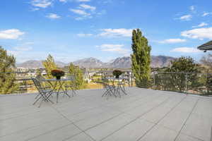 View of patio featuring outdoor dining area, a mountain view, and a residential view