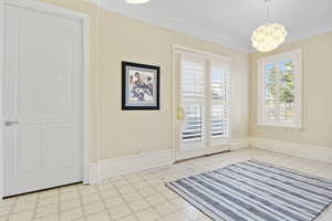 Unfurnished dining area featuring crown molding and tile patterned floors