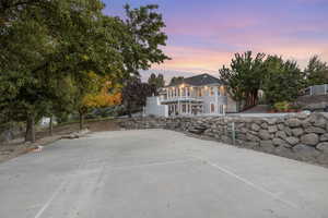 Back of house with a balcony and stucco siding