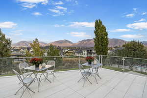 Deck with a patio, a mountain view, a residential view, and outdoor dining area