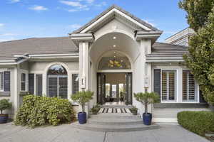 Doorway to property featuring a tiled roof and stucco siding