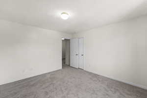 Unfurnished room featuring carpet and baseboards