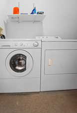 Washroom featuring washing machine and clothes dryer