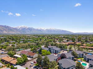 Aerial view of residential area with a mountain backdrop and a pool