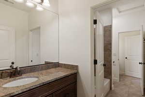 Full bathroom featuring vanity, tile patterned flooring, and shower / bath combination
