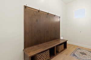Mudroom featuring baseboards and light wood-style floors
