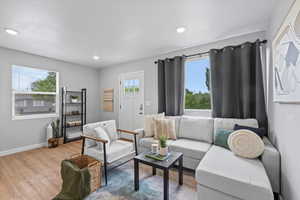 Living area featuring wood finished floors, baseboards, and recessed lighting