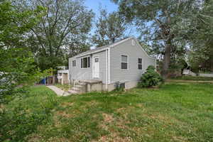 View of property exterior featuring a yard
