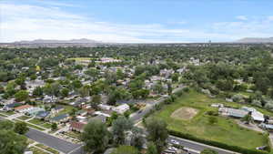 View of property location featuring a mountainous background, nearby suburban area, and a local golf course