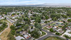 Aerial overview of property's location with a mountainous background and nearby suburban area