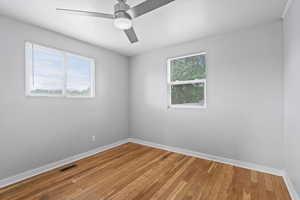 Unfurnished room with baseboards, light wood-type flooring, and a ceiling fan