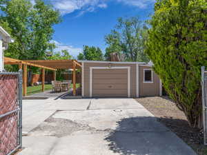 Garage with driveway and fence