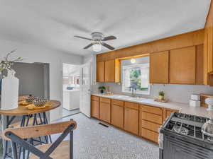 Clean kitchen comes with a new fridge and a nice gas stove
